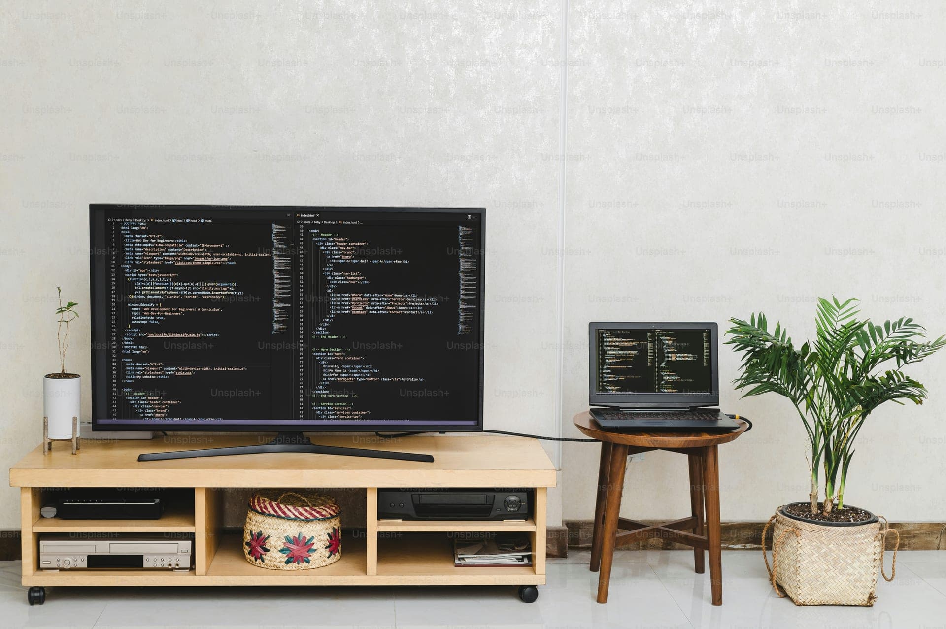 a flat screen tv sitting on top of a wooden stand